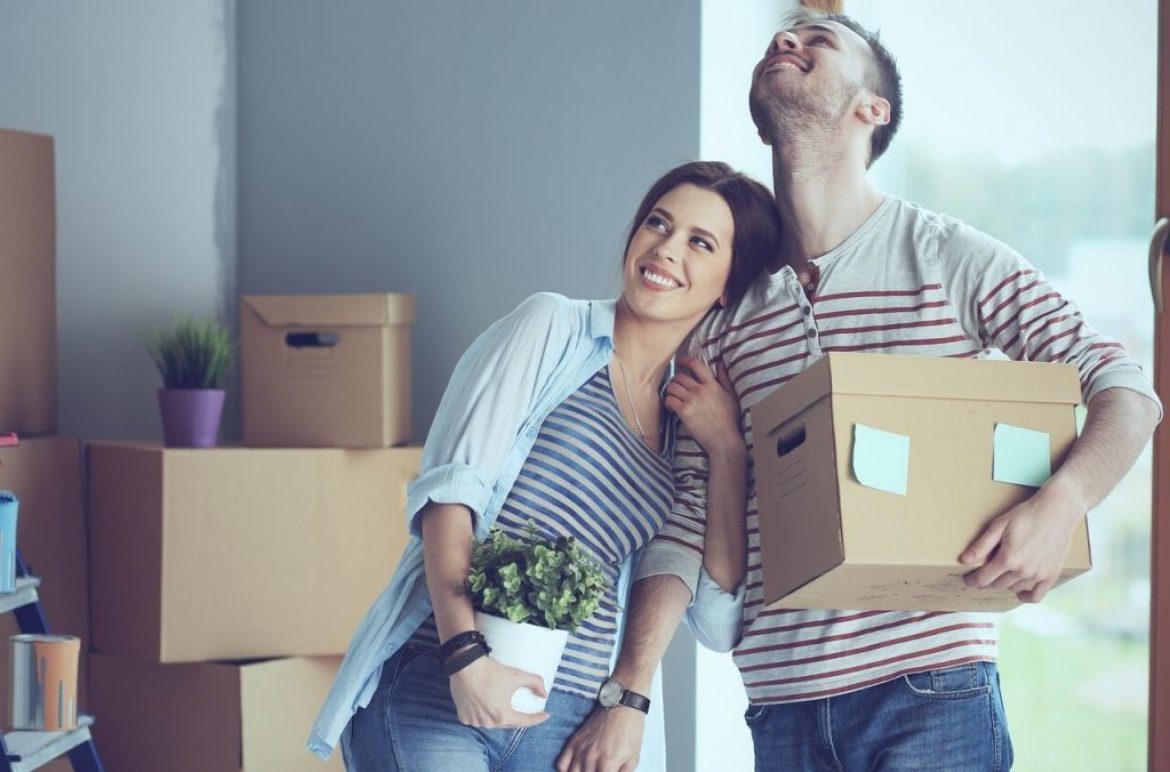 couple holding boxes in home