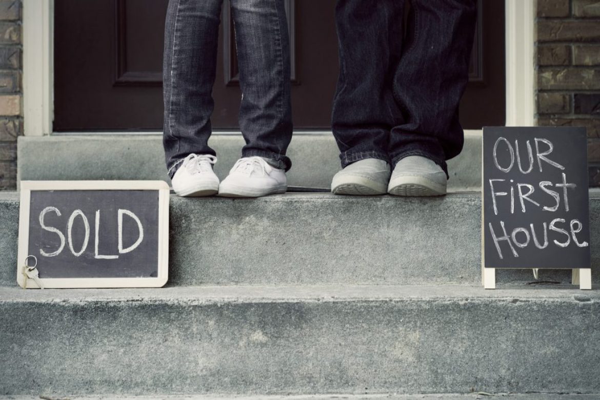 couple sitting on steps of new house