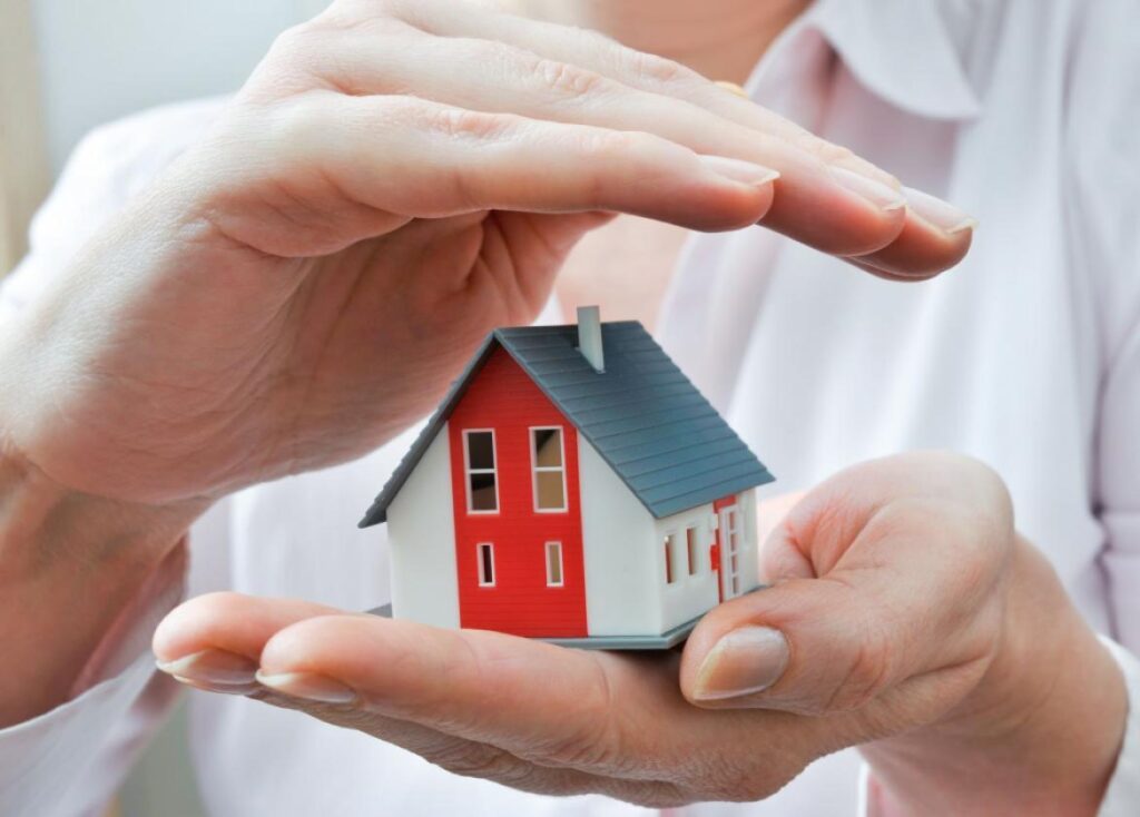 man holding model of house in hands